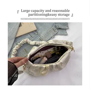 Interior view of off-white gathered cloud bag showing large capacity for cosmetics