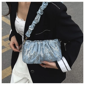 Detail of light blue sequined pleated bag with metallic shine and scrunchie strap