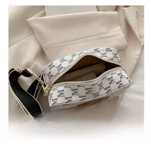 Interior view of monogram crossbody bag showing capacity for wallet and smartphone