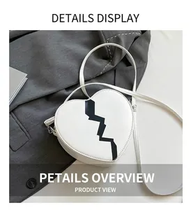 Detail of white heart-shaped crossbody bag with black zigzag contrast and thin strap