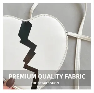 Detail showing high-quality white PU leather and black pattern on heart-shaped bag