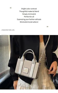 Silver glitter crossbody bag with top handles and square THE BAG logo patch