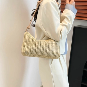 Handwoven straw tote bag with knotted leather straps for casual summer style