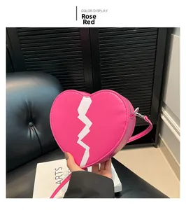 Detail of rose red heart-shaped bag with lightning print and thin shoulder strap