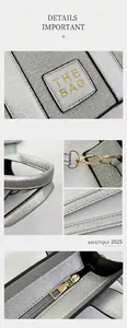 Detail view of silver litchi grain leather bag with gold hardware and THE BAG logo