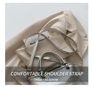 Close-up of silver crackle leather texture with vintage hardware and elegant straps