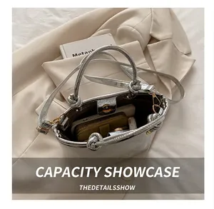 Silver bucket bag detail showing magnetic closure and interior space for daily items