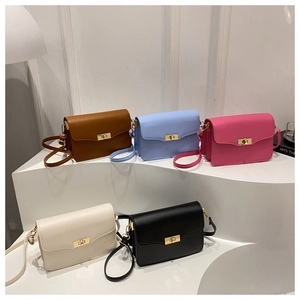 Row of minimalist flap crossbody bags in five colors with golden metallic twist locks