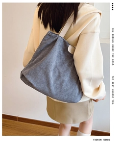 Detail view of the gray corduroy texture and Fashion leather tag on a large tote bag