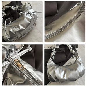 Detail showing metallic silver ruched texture and a cute bow tie on the shoulder bag