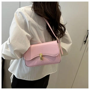 Pink rectangular leather underarm bag with gold metal clasp shown on a model's shoulder