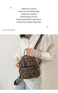 Detailed view of brown letter print backpack with golden zippers and rivet accents