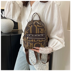 Detail of trendy letter print backpack with metal studs and adjustable PU straps
