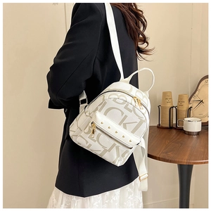 Detail of white PU leather backpack with LUCKY letter print and gold stud zipper pocket