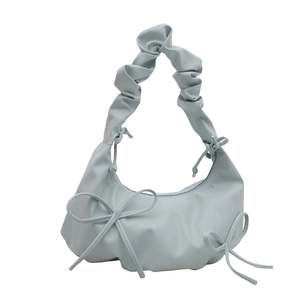 Light blue ruffled cloud bag with bow accents and soft shoulder strap for women