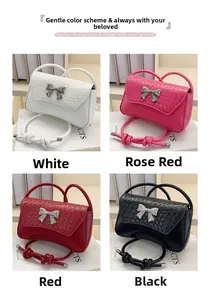 Detail view of four mini crossbody bags in white, red, magenta, and black with bows