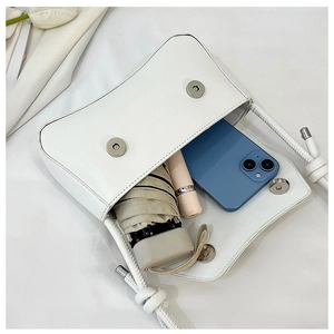 Detail view of the white square bag interior showing storage for phone and umbrella