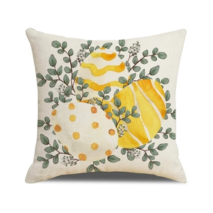 Easter throw pillow with watercolor eggs and eucalyptus leaves on linen texture