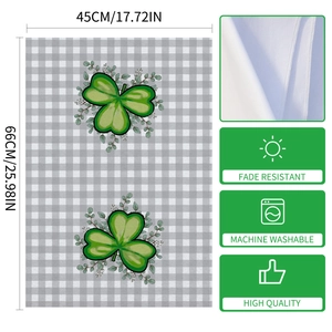 Detail of St. Patrick's Day microfiber towel with green clover pattern and stitched edges