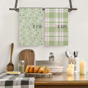 Close-up of Easter kitchen towels with Be Kind and Be Hoppy prints on a kitchen counter