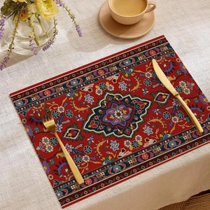 Detail of bohemian linen placemat with red Persian carpet pattern and heat insulation