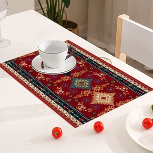 Detail of red Bohemian placemat with intricate ethnic patterns on a white table