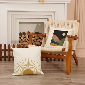 Boho geometric throw pillow covers with sun and mountain prints in a cozy home setting
