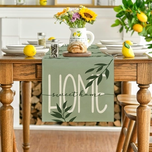 Detailed close-up of sage green sage green table runner with HOME SWEET HOME typography