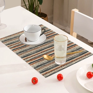 Close-up of bohemian linen placemat with geometric patterns on a dining table
