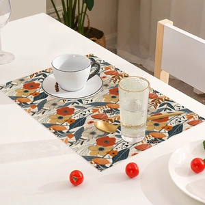 Detail of bohemian linen placemat with vintage floral pattern and stitched edge
