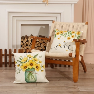 Linen daisy and sunflower pillow covers with Fall in Love text on a vintage chair