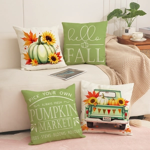 Detail view of four autumn pillow covers with pumpkin sunflower and pickup truck prints