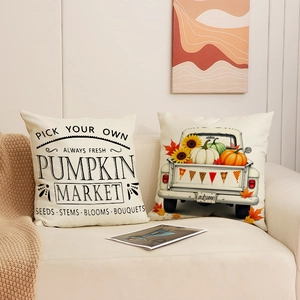 Set of autumn harvest pumpkin pillow covers with vintage truck print on a cozy beige sofa