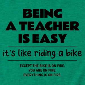 Close-up of a green cotton T-shirt featuring a humorous teacher quote in black bold text