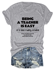 Detail of grey graphic t-shirt with slogan and distressed denim shorts outfit set