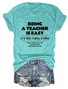 Flat lay of mint green teacher slogan T-shirt with distressed denim shorts casual set