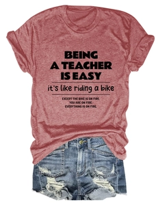 Close-up detail of casual brick red teacher slogan T-shirt with denim shorts outfit