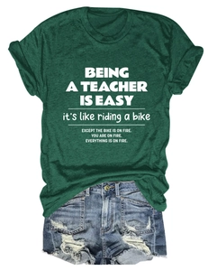 Flat lay of teacher slogan dark green T-shirt with vintage frayed denim shorts