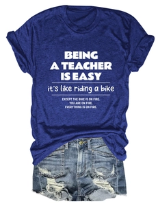 Close-up of navy blue crewneck T-shirt with white text and distressed denim shorts