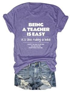 Flat lay of purple cotton T-shirt with teacher quote print and frayed denim shorts
