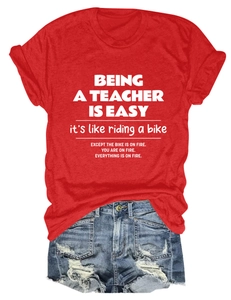 Close-up of red teacher t-shirt fabric texture and humorous quote print detail