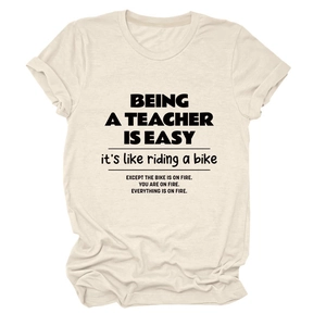 Flat lay of a beige cotton T-shirt featuring a teacher quote print and round neckline