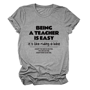 Detail of grey teacher t-shirt with rolled sleeves and black typography print