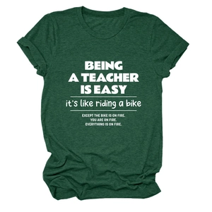 Detail of dark green cotton T-shirt featuring white Being a Teacher Is printed text