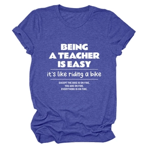 Close-up of blue heather cotton T-shirt featuring white teacher slogan typography