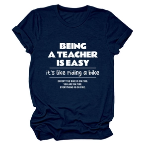 Detail of navy blue cotton T-shirt featuring 'Being a Teacher is Easy' slogan print