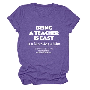 Flat lay view of a purple crew neck cotton T-shirt featuring a white teacher quote print
