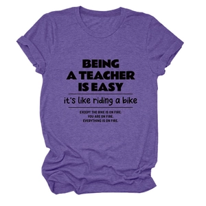 Detail of dark purple crew neck teacher t-shirt showing fabric texture and typography