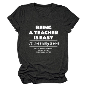 Detailed close-up of dark grey teacher slogan cotton t-shirt with white humor text