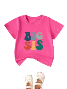 Detail of pink cotton t-shirt with BIG SIS colorful text print for girls